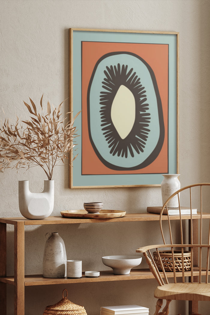 Framed abstract avocado poster on a home interior wall with decorative ceramics and wooden furniture