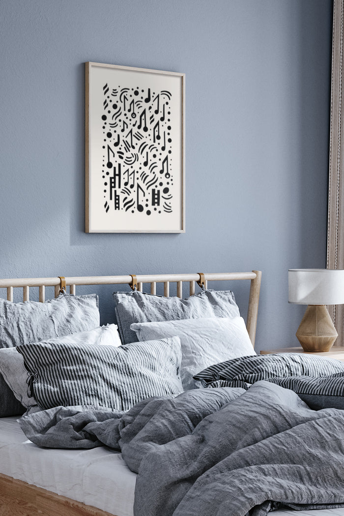 Modern abstract black and white art poster framed on bedroom wall above cozy bed with pillows
