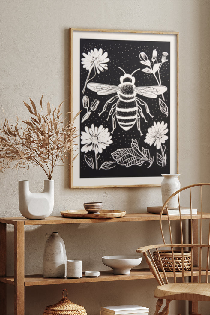 Black and white bee and daisy floral artwork poster displayed in a modern interior setting