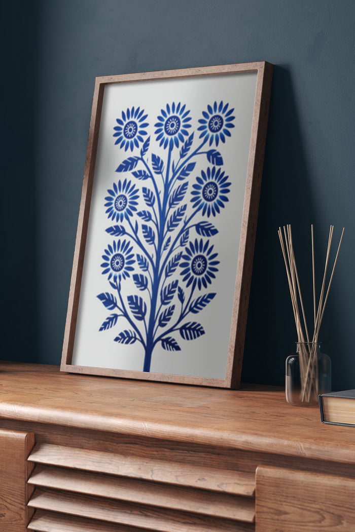 Blue Floral Art Print Poster in Brown Wooden Picture Frame on Sideboard Against Dark Wall