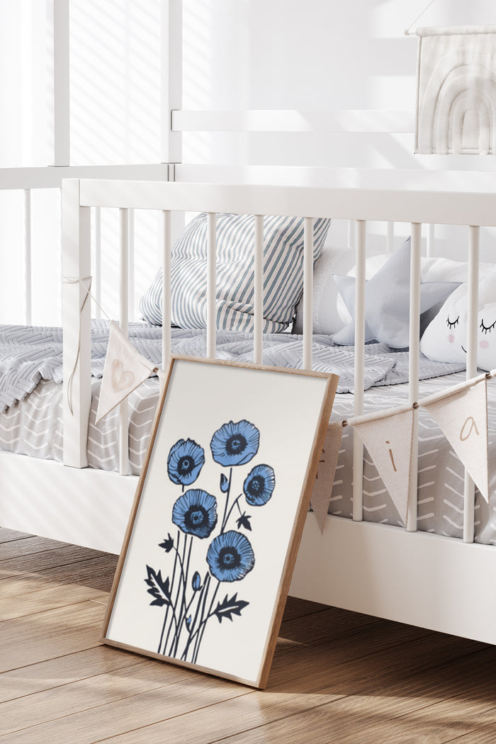 Nursery room decoration with a framed poster of blue poppies artwork