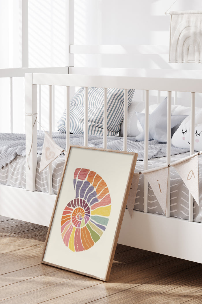 Colorful abstract nautilus shell poster leaning against white crib in a child's nursery room