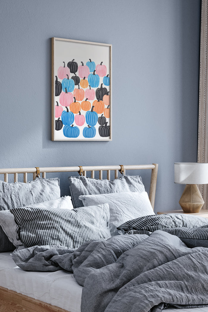 Colorful abstract pumpkins poster framed on a bedroom wall above a bed with grey bedding