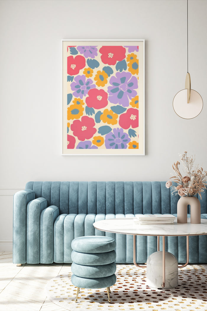 Bright and colorful floral patterned artwork poster hung above a blue velvet sofa in contemporary interior design setting