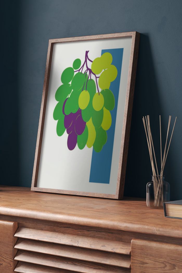 Modern geometric graphic artwork of a cluster of grapes in a framed poster on a wooden dresser with home decor