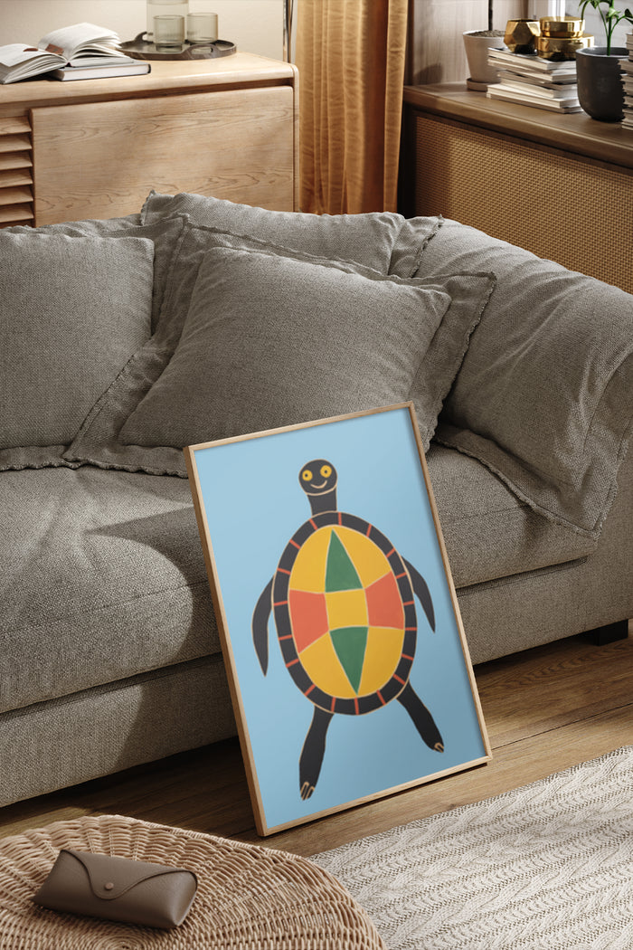 Colorful geometric turtle artwork poster leaning against a sofa in a cozy room setting