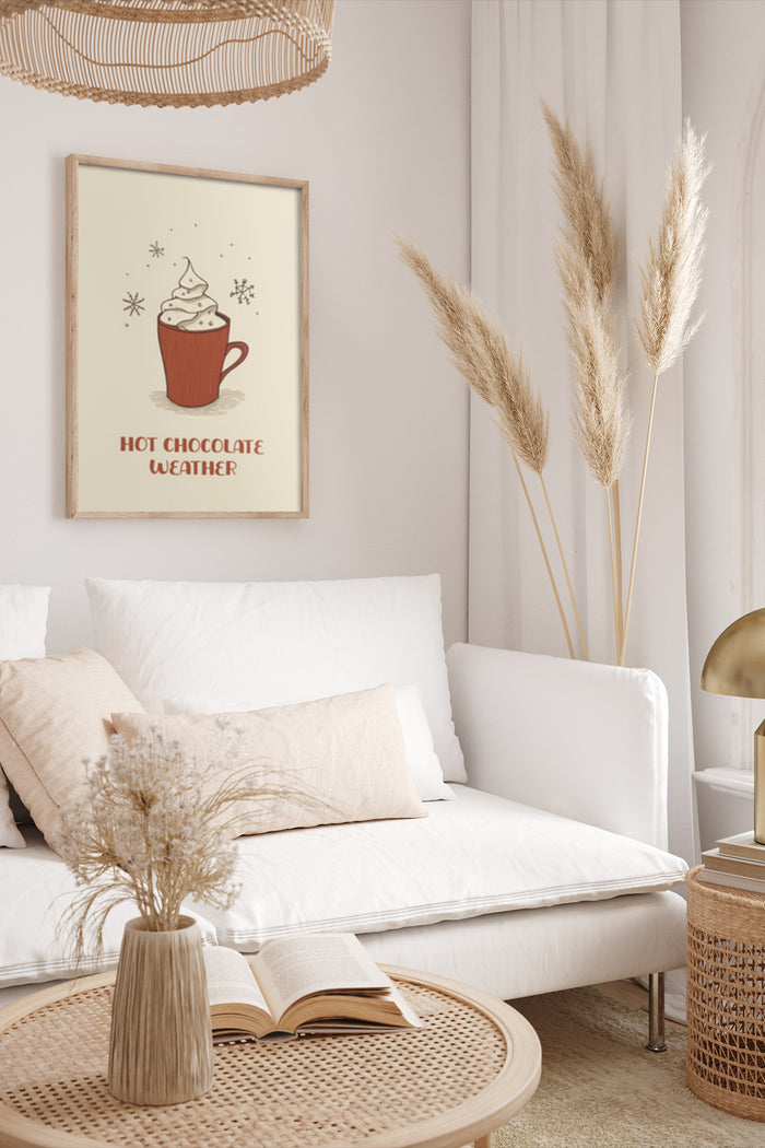 Stylish home interior with 'Hot Chocolate Weather' poster, cozy white couch and decorative pampas grass