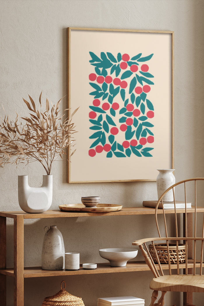 Minimalist botanical poster with teal leaves and red berries framed on a beige wall in a stylish interior