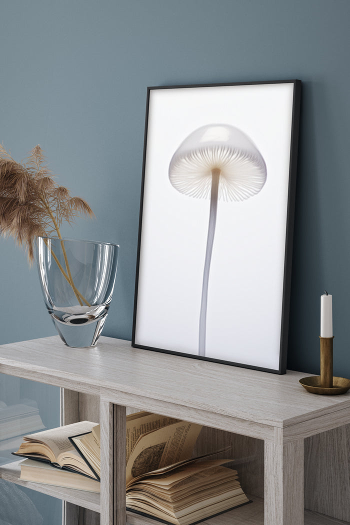 Minimalist black and white mushroom poster framed on wall in modern home decor setting with decorative items