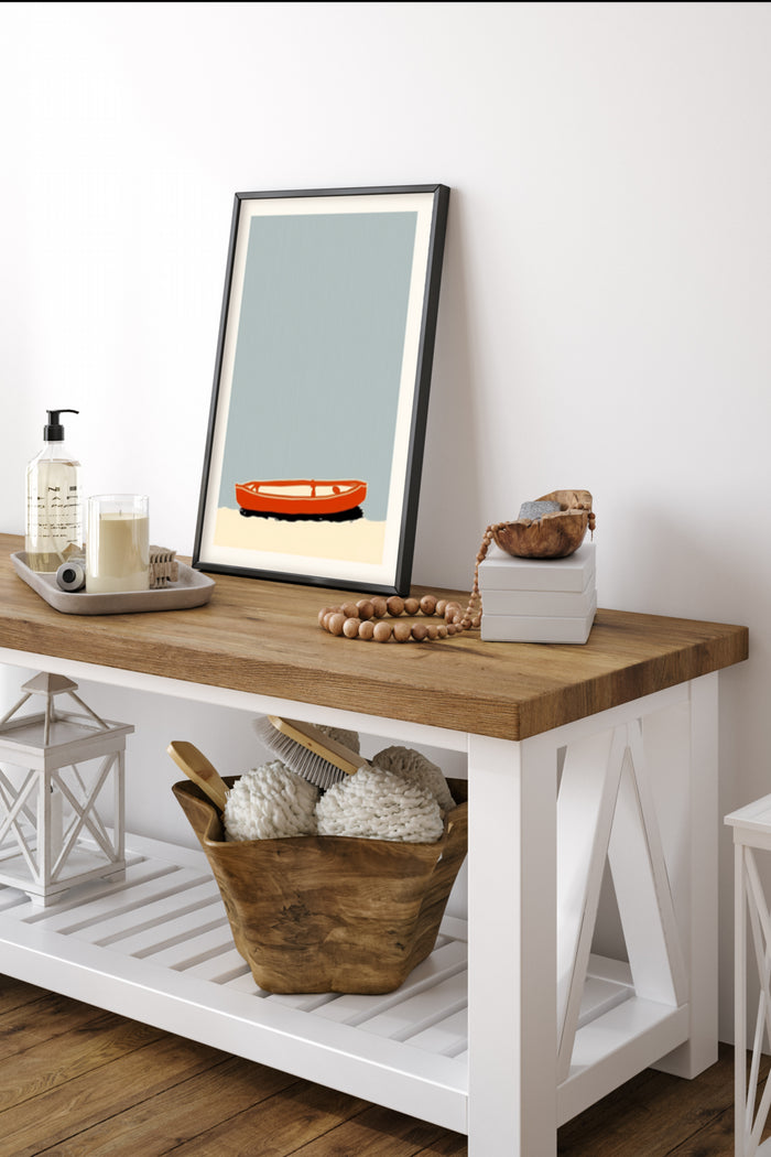 Minimalist poster of an orange ashtray against a pale blue background displayed in a modern home interior
