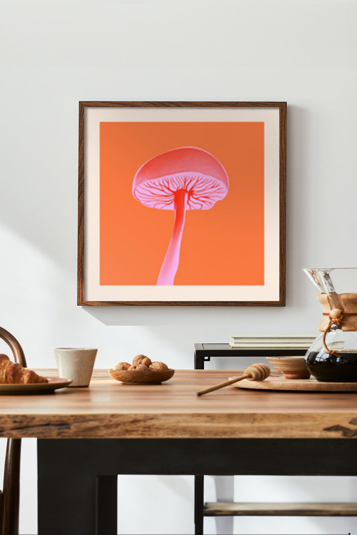 Stylish framed poster of a modern mushroom illustration in orange hue displayed in a cozy home setting