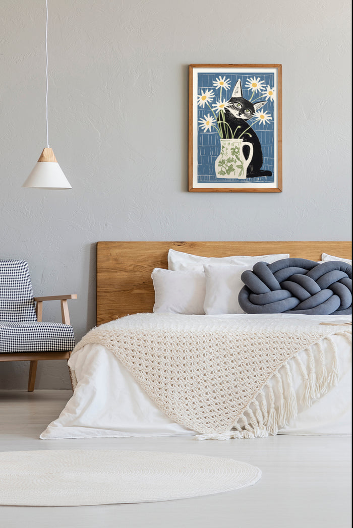 Contemporary bedroom decor showcasing framed poster of black cat in vase with white daisies