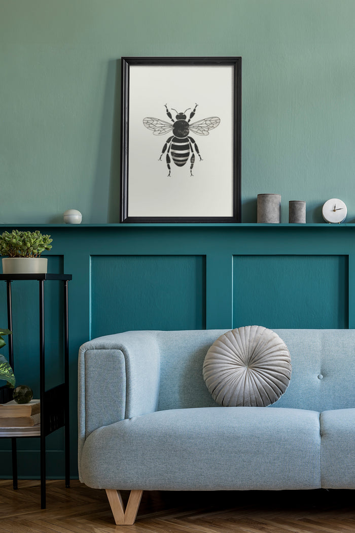 Black and white bee poster framed on teal wall above blue couch in stylish living room interior