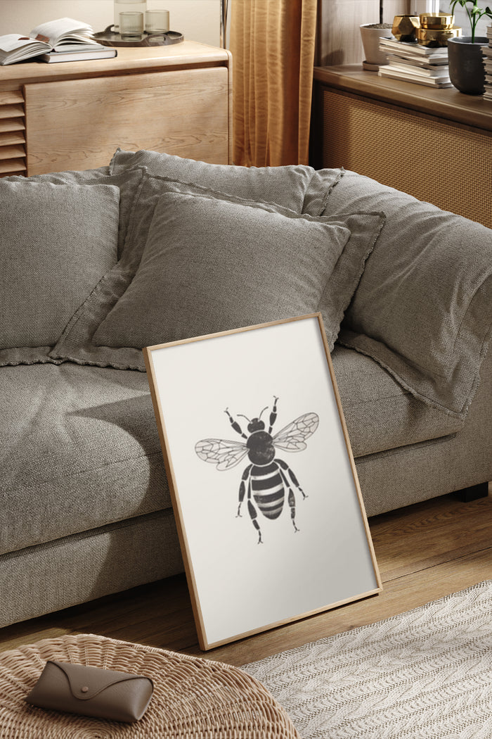 Black and white modern bee artwork poster in a contemporary living room setting