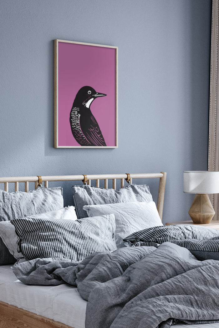 Stylish modern bird artwork with a pink background framed poster above a bed with grey bedding