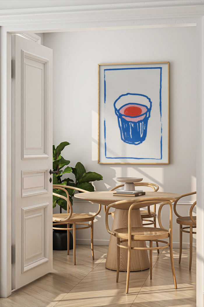 Contemporary art poster featuring a blue cup with red circle design displayed in a minimalist dining room setting