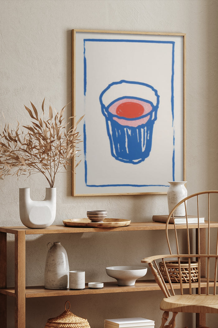 Modern abstract painting of a blue paint bucket with red content framed on a wall in a stylish interior