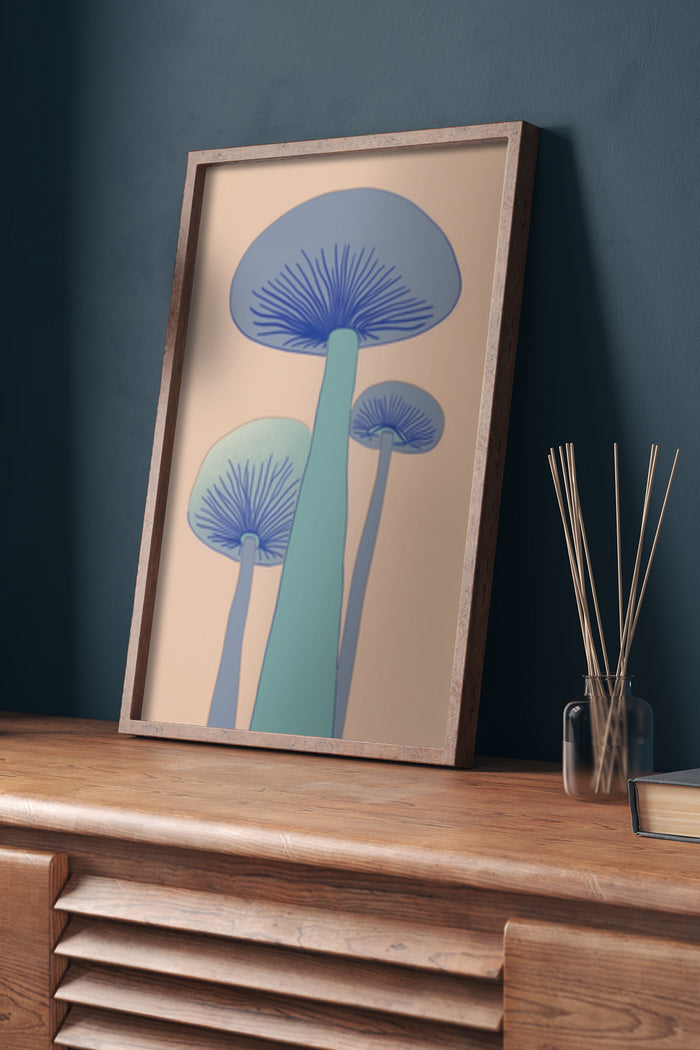 Stylish modern artwork of blue mushrooms with a beige background in a wooden frame on a wooden dresser against a dark wall