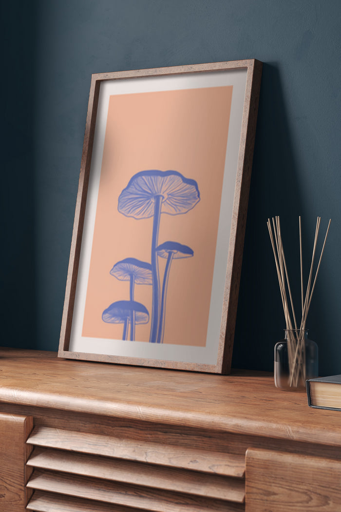 Contemporary blue mushroom design poster in wooden frame on desk with decorative items