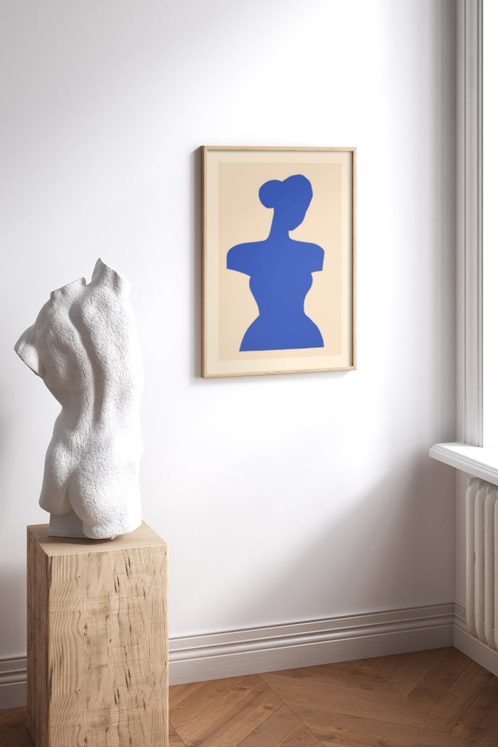 Contemporary blue silhouette artwork displayed on a wall in a room with a white sculpture