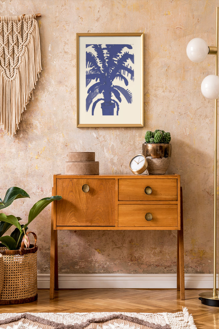 Botanical artwork of tropical palm in a gold frame above a wooden console table within a tastefully decorated room