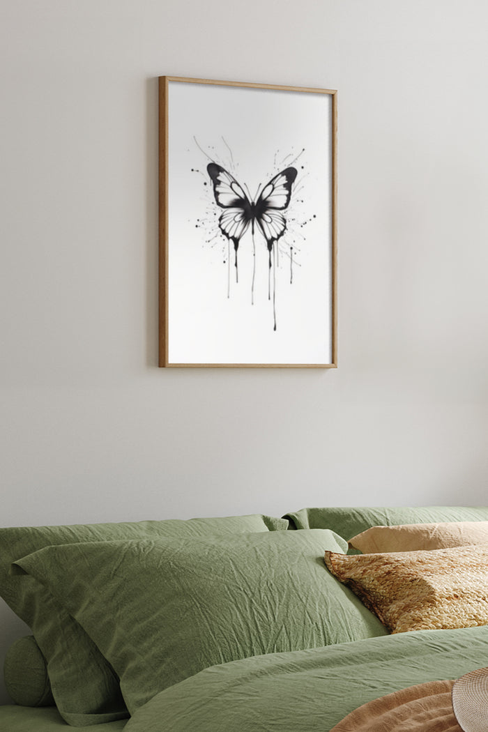 Modern black and white butterfly ink splatter art poster framed in a bedroom setting