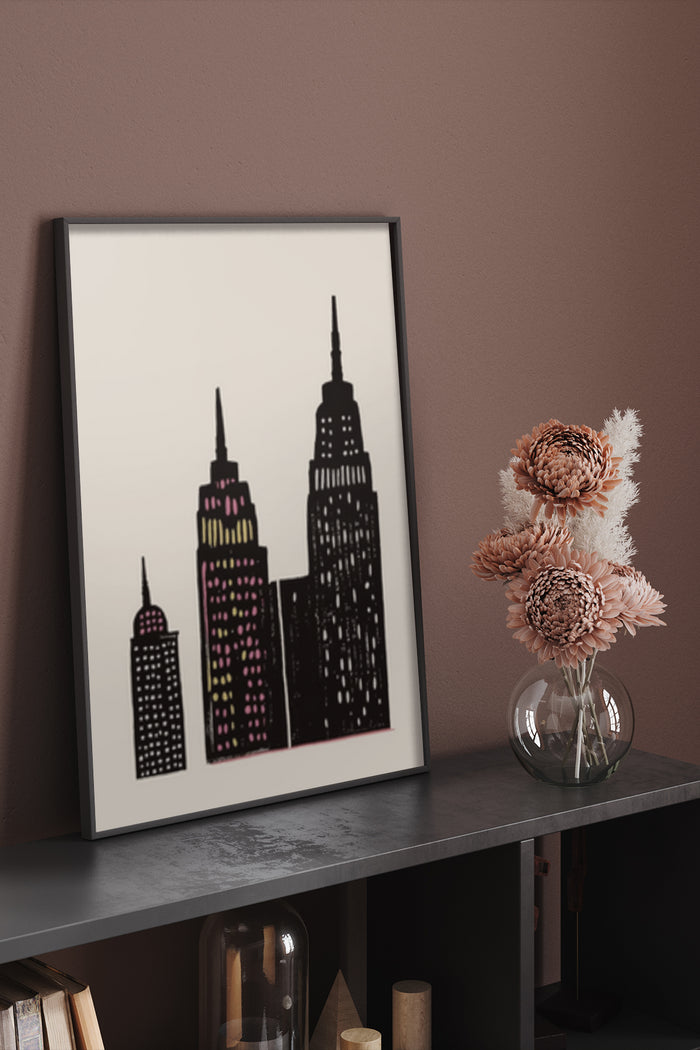 Stylized modern cityscape poster featuring iconic skyscrapers, displayed on a shelf in a contemporary room setting
