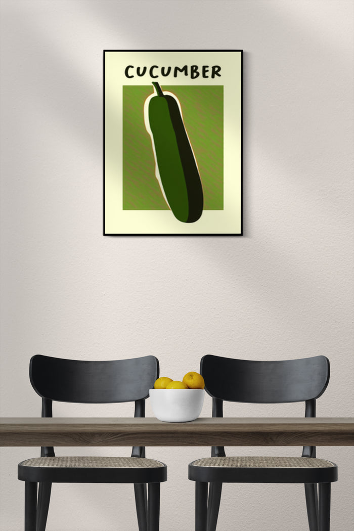 Modern styled poster of a cucumber on the wall above two black chairs and a wooden table with a bowl of lemons
