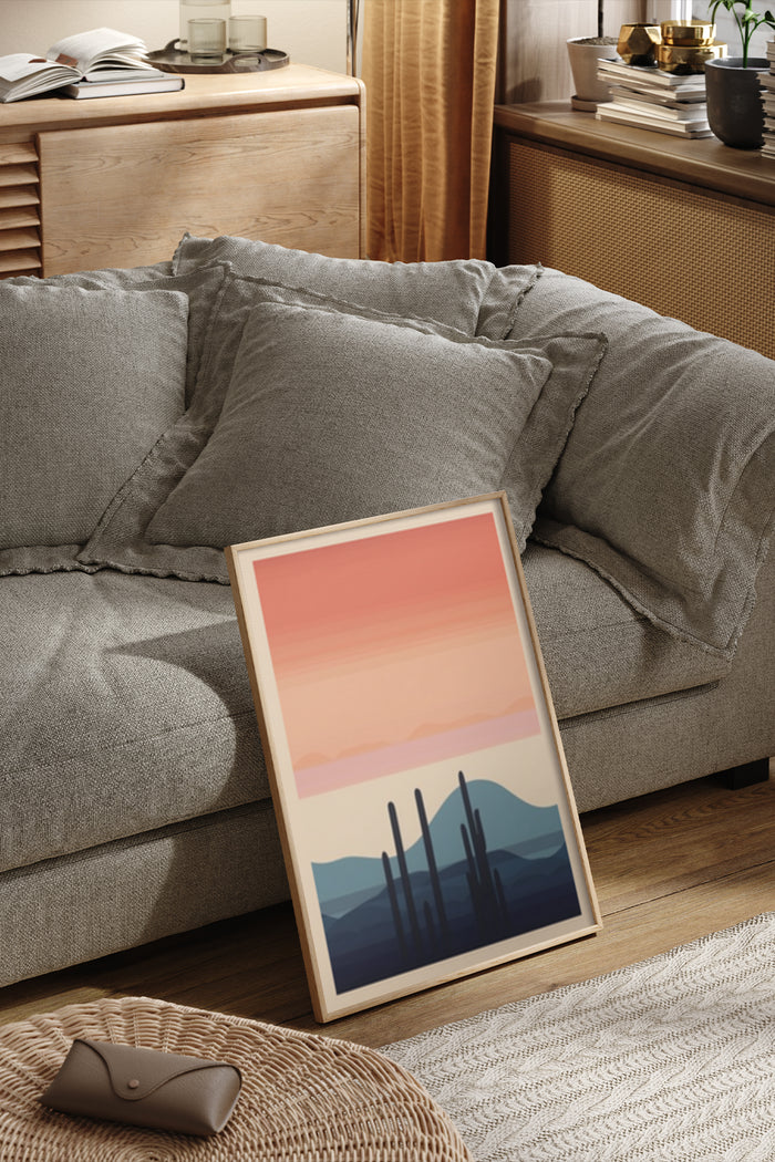 Stylish modern desert cactus artwork leaning against a couch in a cozy home interior