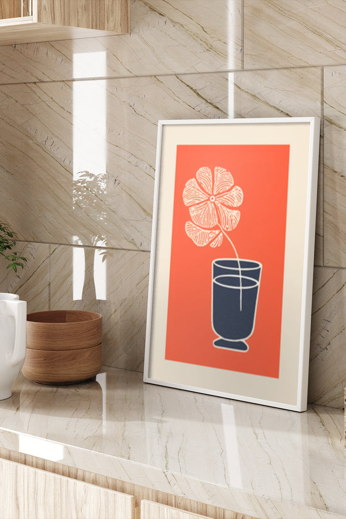 Contemporary red and blue floral poster art framed and displayed on a marble wall beside wooden bowls and a plant