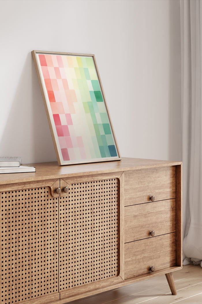 Abstract modern geometric pixel pattern poster in wooden frame on a stylish sideboard