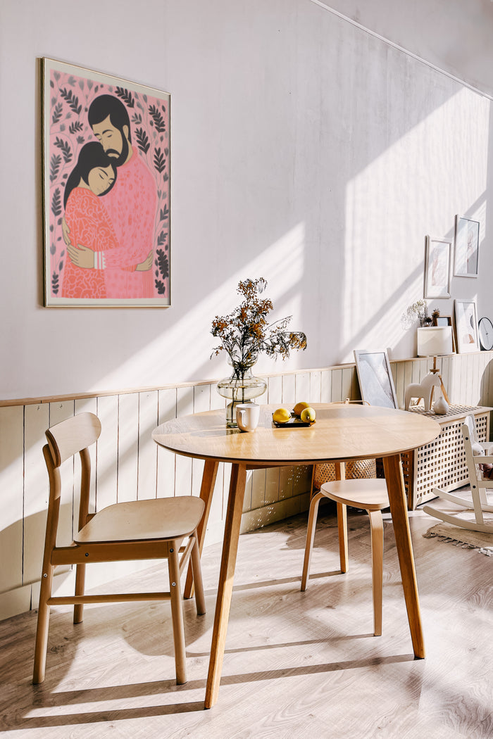 Contemporary home decor featuring minimalist furniture and a framed poster of two embracing figures in a stylized illustration
