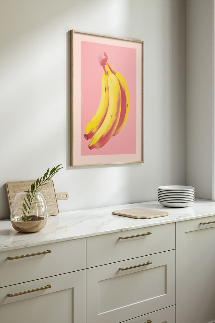Stylish framed poster of yellow bananas on a pink background in a contemporary kitchen setting