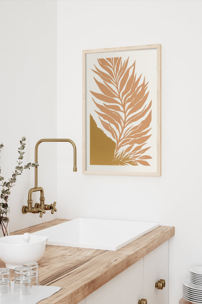 Stylish golden leaf design poster framed on a wall above a wooden bathroom countertop