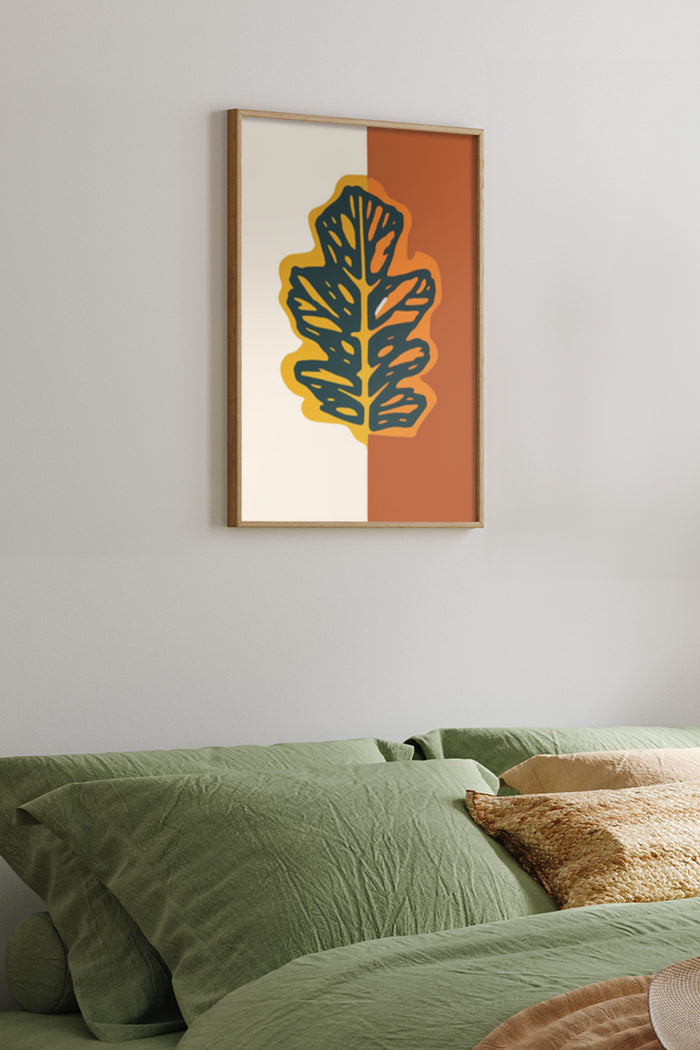 Contemporary graphic leaf design poster framed on bedroom wall above green bedspread