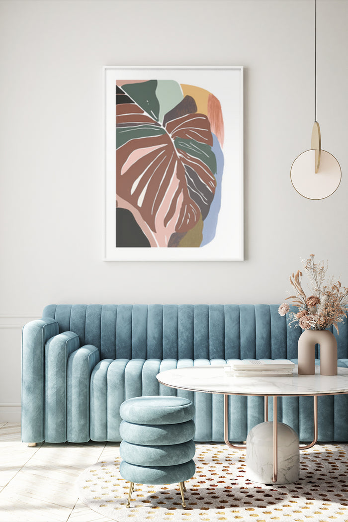 Contemporary leaf pattern artwork poster displayed above velvet sofa in elegant living room interior