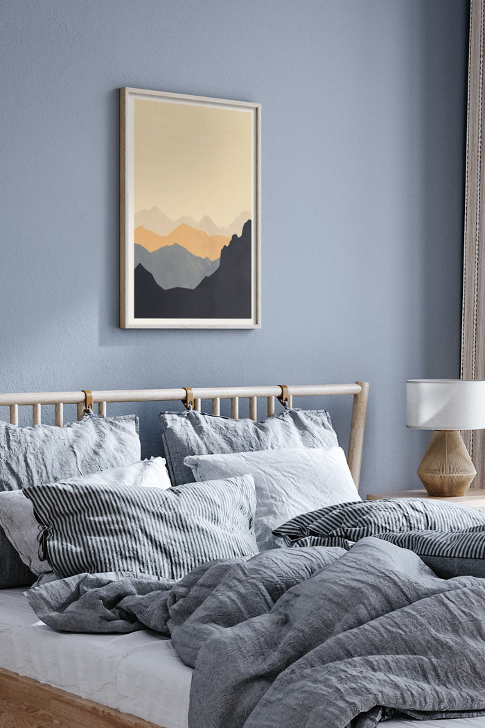 Modern minimalist mountain landscape poster hanging in a cozy bedroom with grey bedding and blue wall