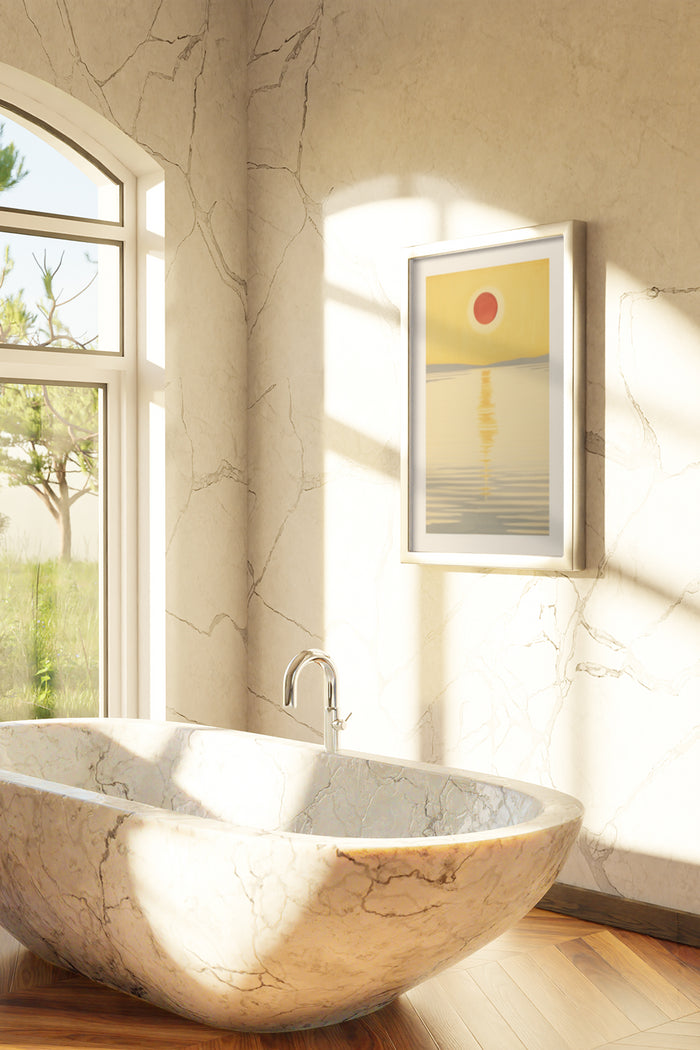 Modern minimalist sunrise seascape poster framed on the wall above an elegant marble bathtub in a sunlit bathroom with greenery outside the window
