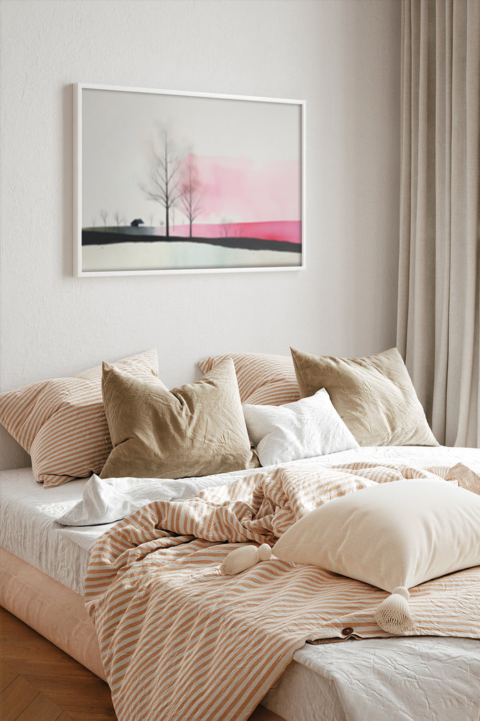 Contemporary pastel pink and grey landscape painting in a stylish bedroom setting above a bed with striped linens