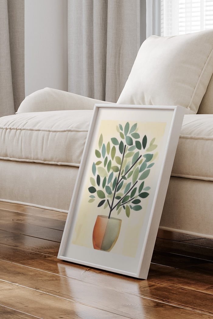 Contemporary styled framed poster of a potted plant artwork leaning against a sofa in a living room