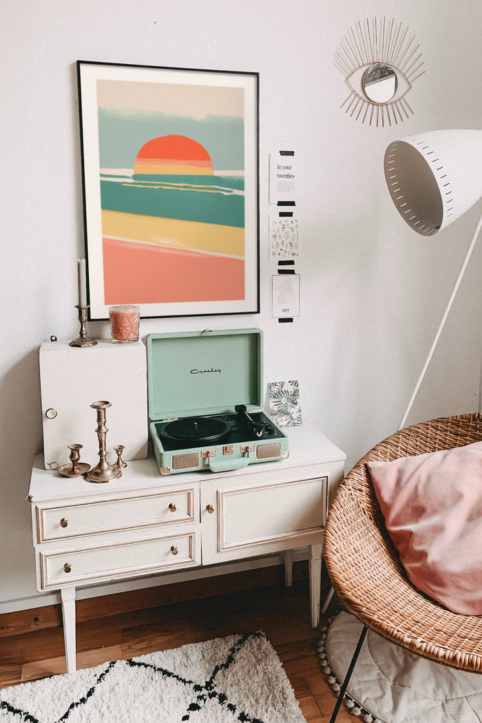 Boho chic interior with modern retro sunset poster, vintage record player, and decorative mirror