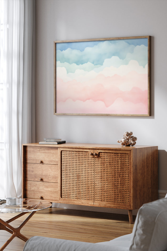 Pastel gradient clouds painting displayed above a mid-century modern wooden sideboard in a cozy interior