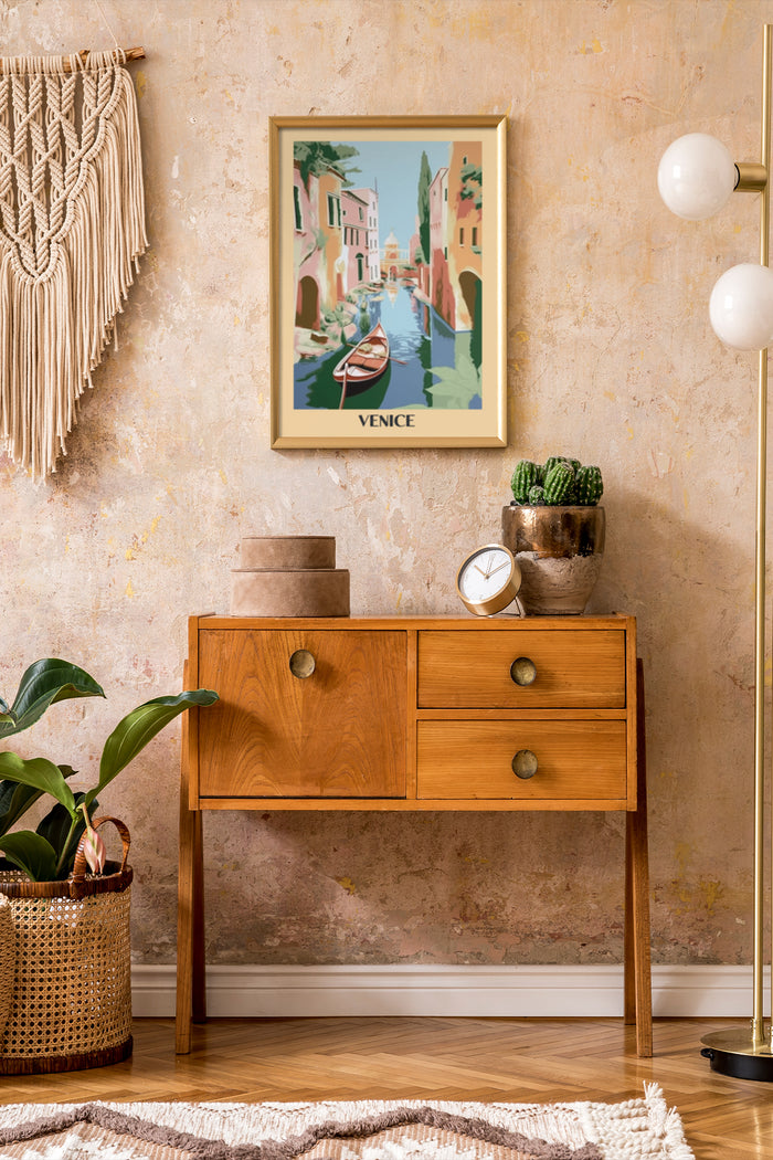 Vintage Venice travel poster framed on a textured wall above a wooden console with decor