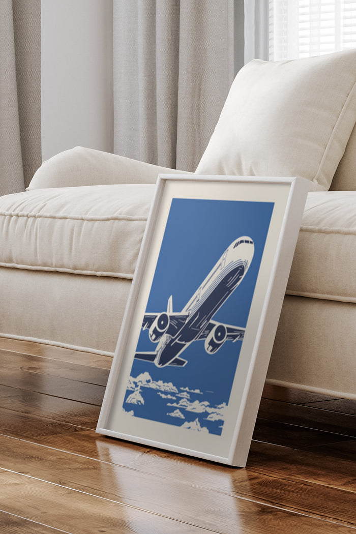 Vintage airplane poster with blue background in a white frame positioned against a sofa in a living room setting