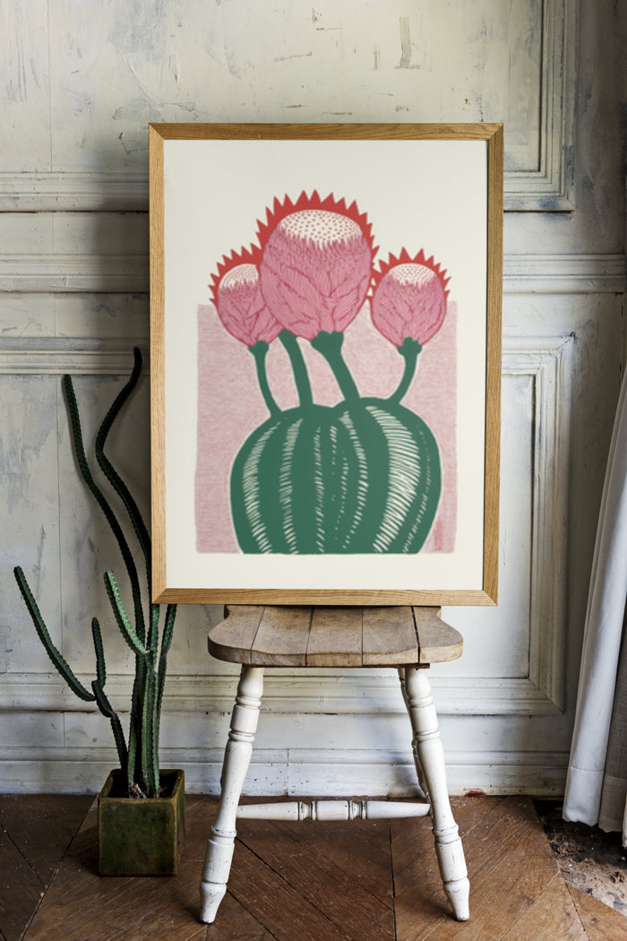Retro style botanical art poster of cactus with pink flowers on wooden easel