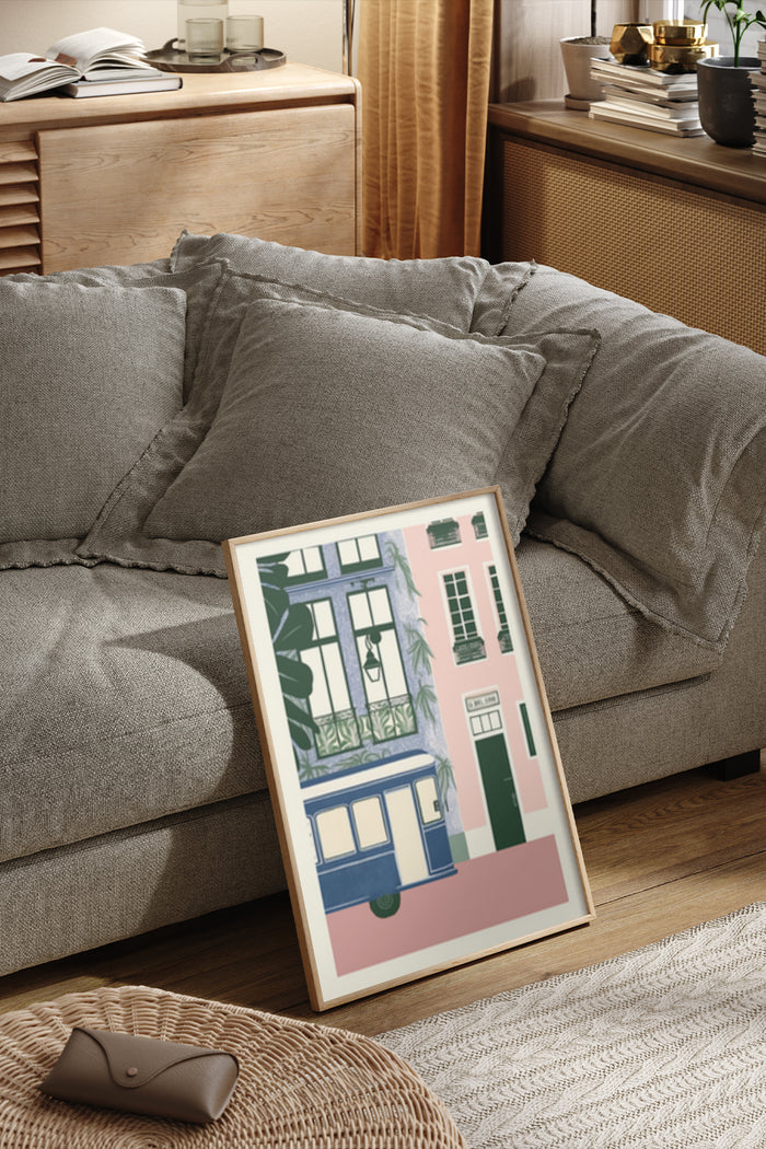 Vintage-styled artwork of a tram and European buildings in a framed poster leaning against a sofa in a cozy living space