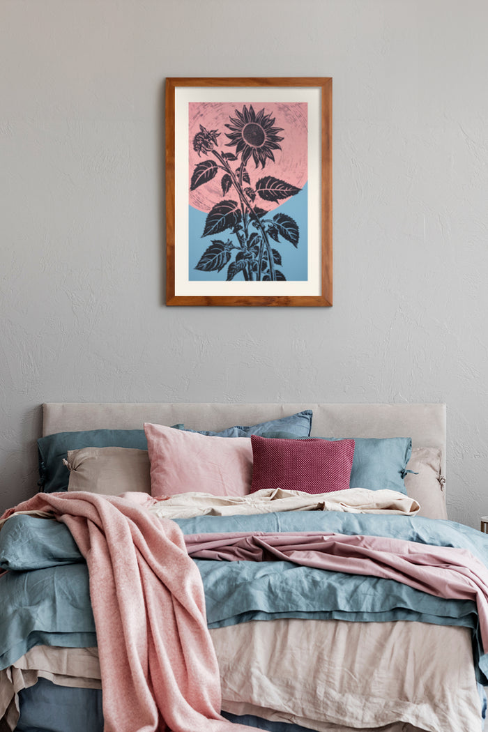 Vintage sunflower poster with pink and blue background hanging above bed in a modern bedroom setting