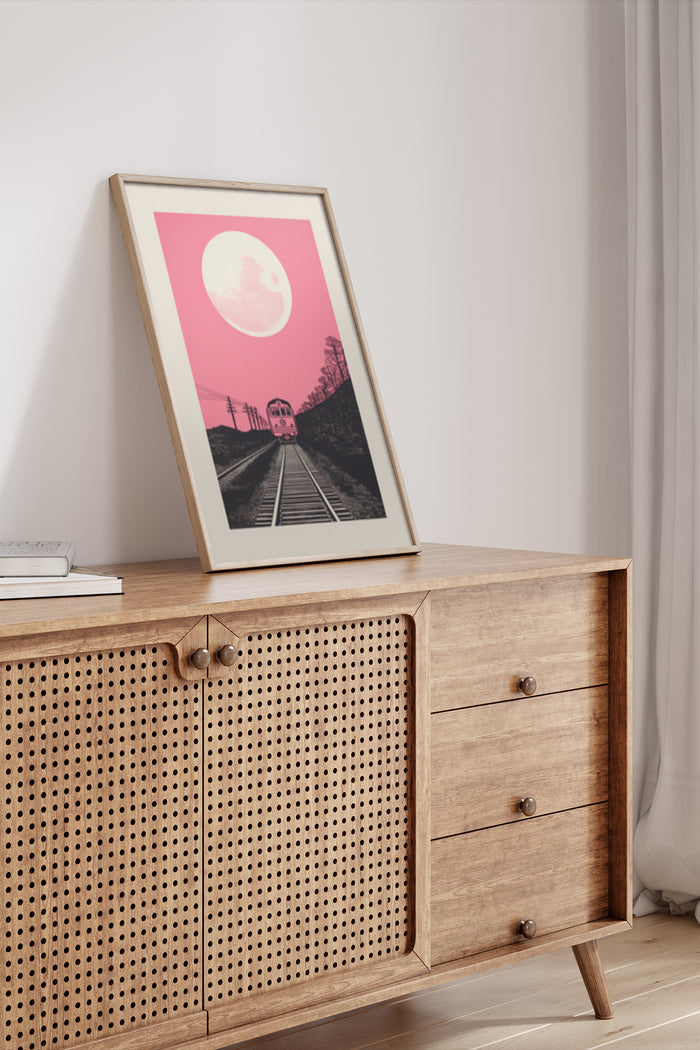 Vintage style poster of a train on tracks with a pink sky and full moon in a room setting