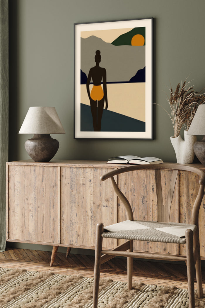 Abstract artwork of a person's silhouette on the beach at sunset hanging above a wooden sideboard in a stylish living room interior