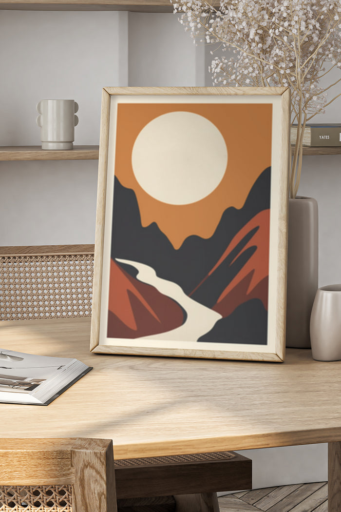 Modern abstract art poster featuring stylized mountain and sun in wooden frame on home interior shelf